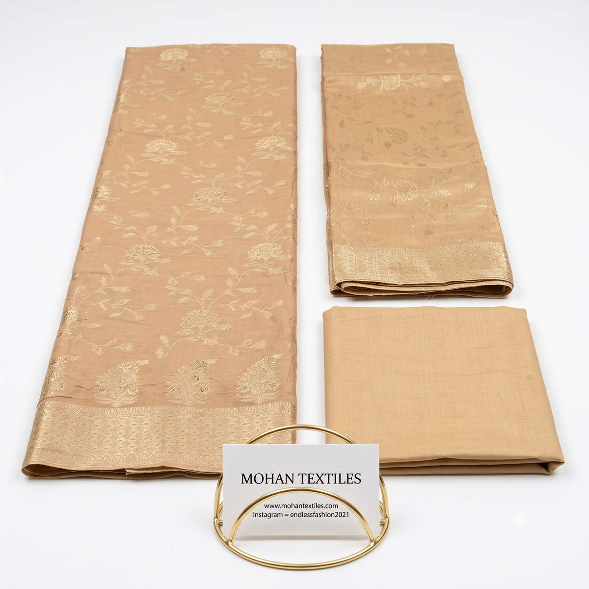 Flat lay of Beige unstitched Banarasi style party wear dress material, featuring intricate gold zari floral weaving and a matching dupatta, available at Mohan Textiles.