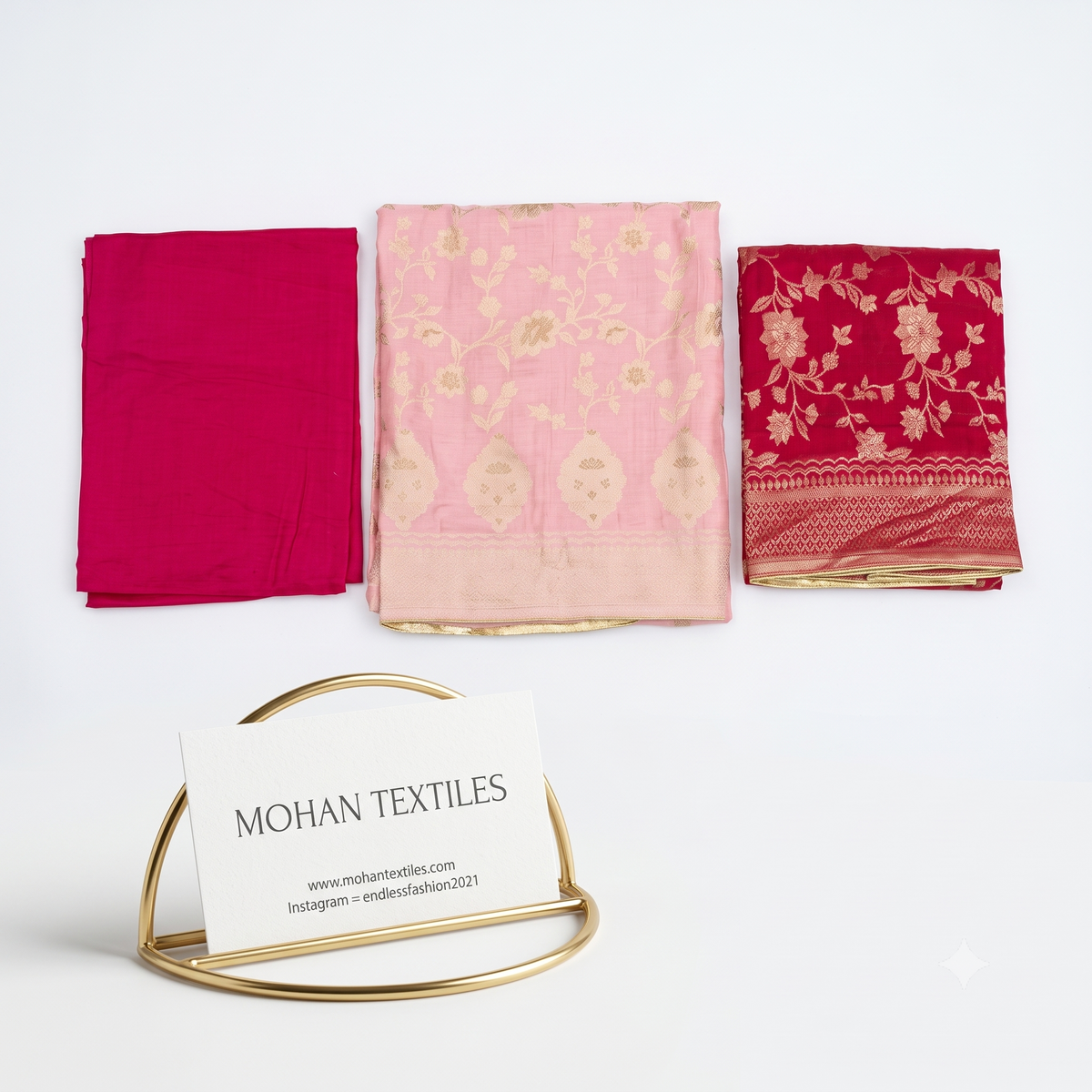 Flat lay of Blush Pink unstitched Banarasi style party wear dress material, featuring intricate gold zari floral weaving and a matching dupatta, available at Mohan Textiles.
