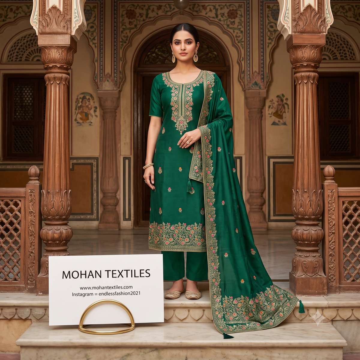 Indian model wearing Bottle green embroidered short-sleeve Punjabi suit with heavy border dupatta standing in traditional haveli lobby.