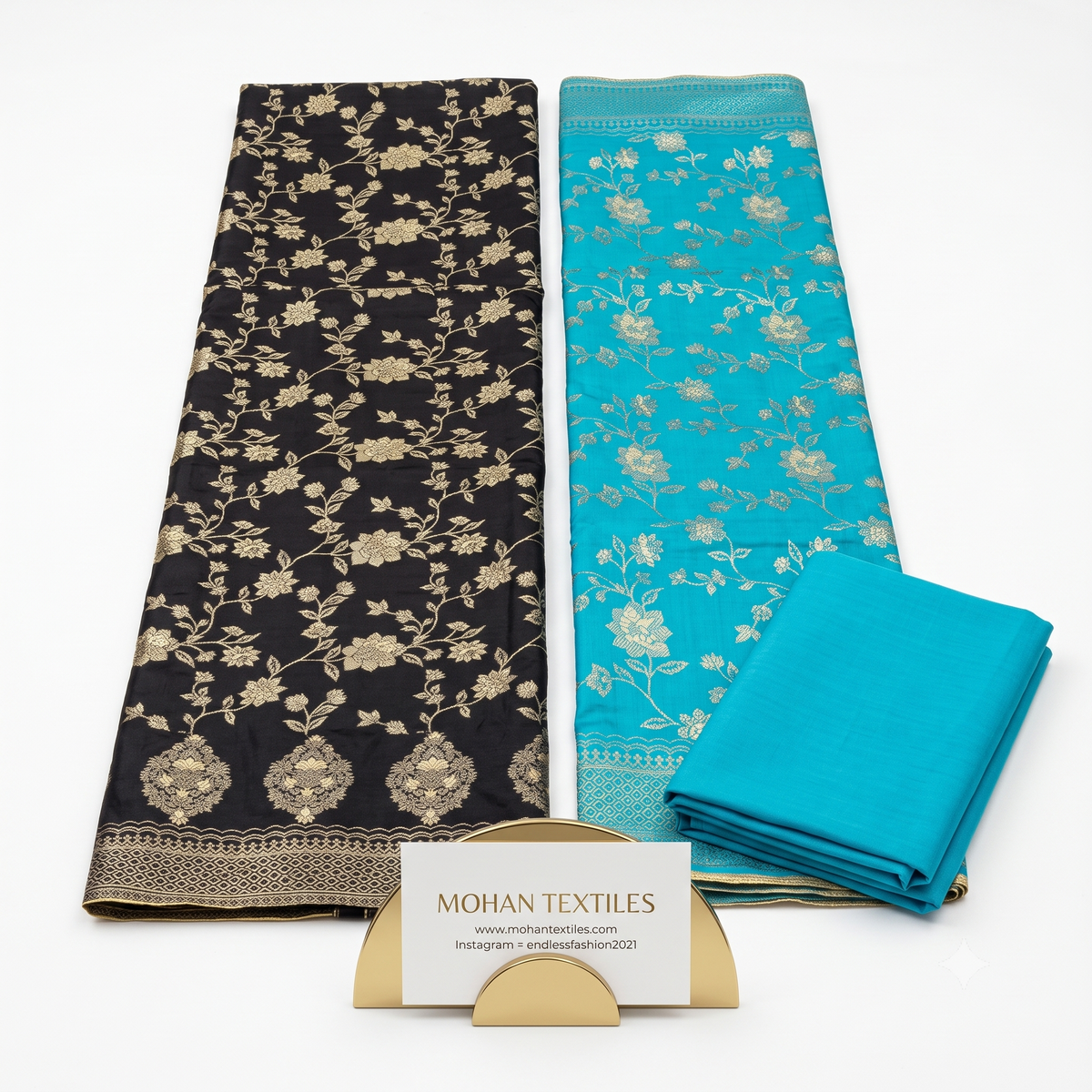 Flat lay of Midnight Black & Blue unstitched Banarasi style party wear dress material, featuring intricate gold zari floral weaving and a matching dupatta, available at Mohan Textiles.