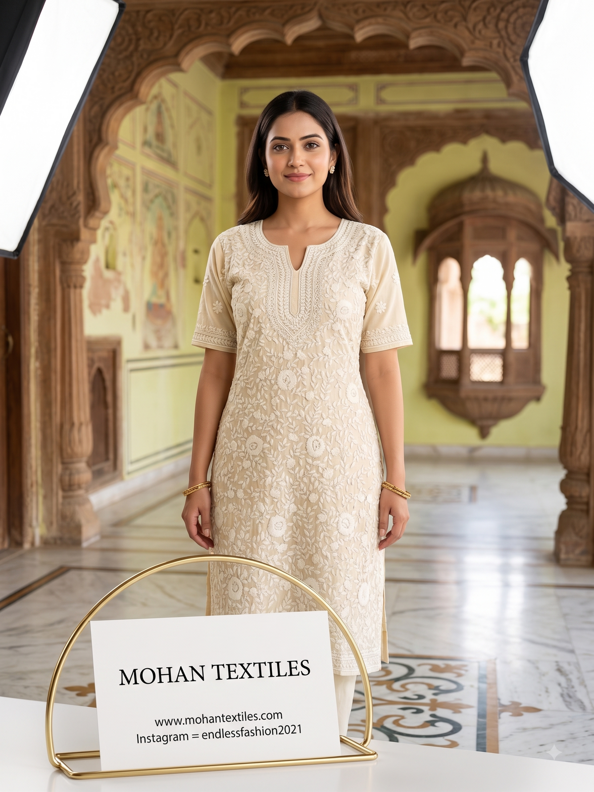 A woman stands in an ornate indoor corridor wearing a lemon-colored phulkari embroidered kurta dress. A sign in the foreground reads 'MOHAN TEXTILES' with website and Instagram details.