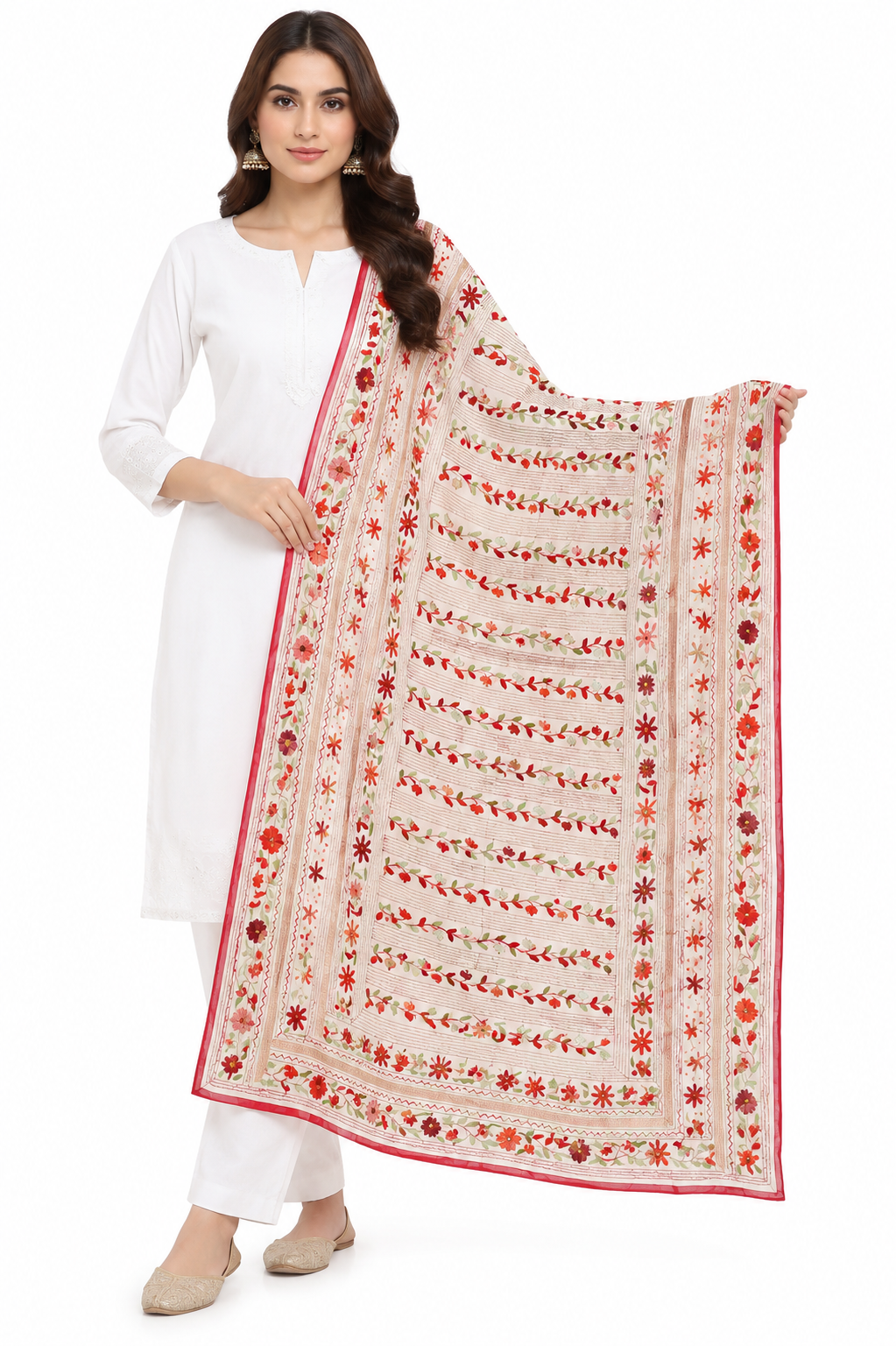 A woman modeling a white kurta and white pants with a large cream dupatta featuring red and orange floral embroidery and a red border, set against a plain white background.