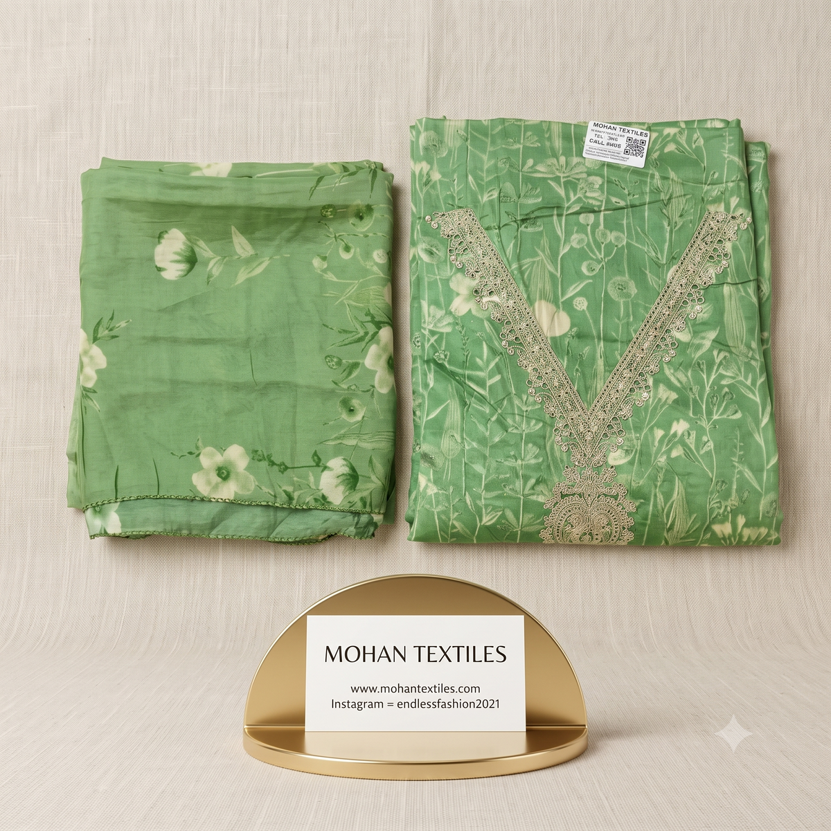 
Folded sage green botanical printed unstitched suit material with embroidered V-neckline and matching floral dupatta on beige linen background