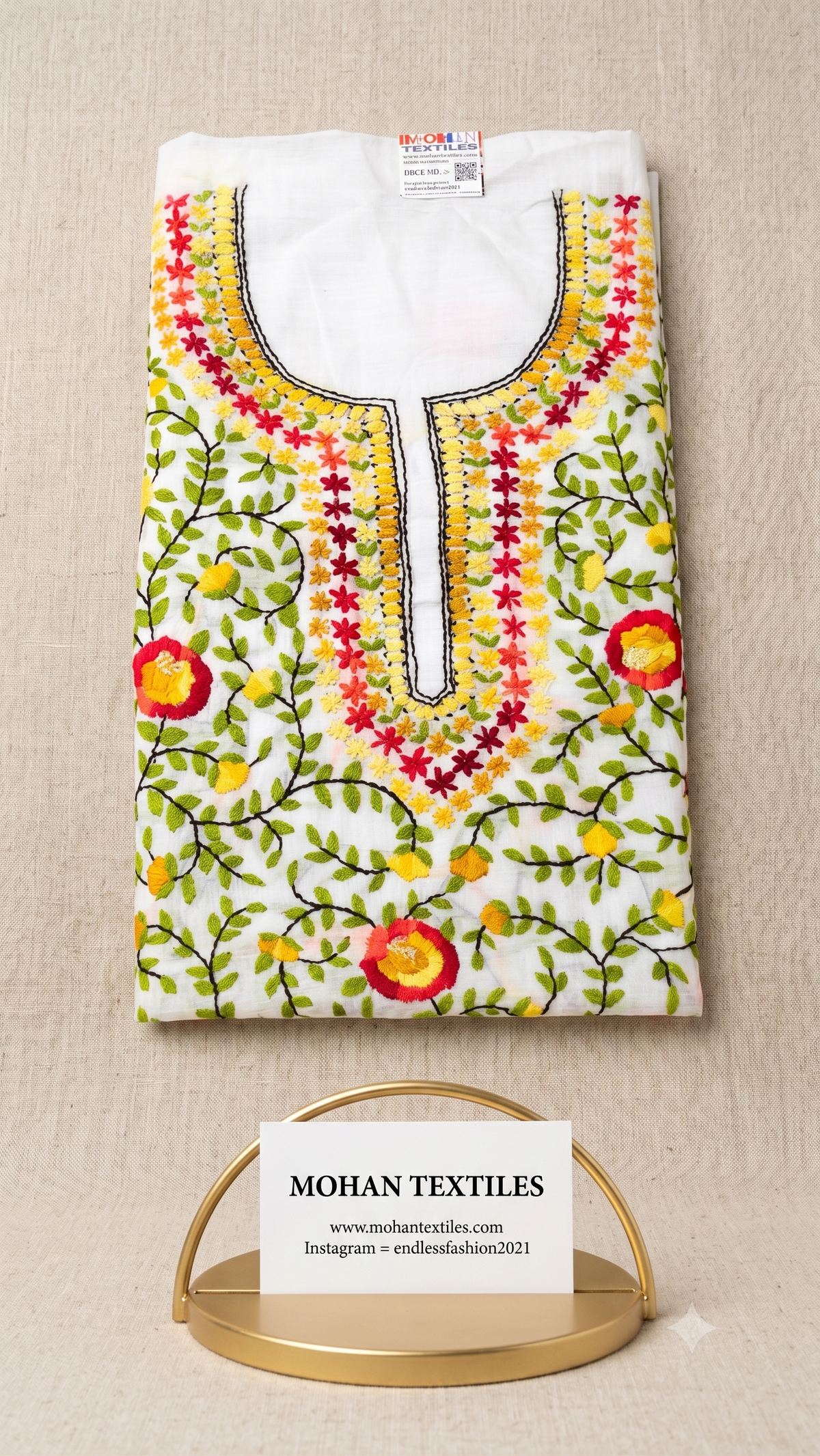 White cotton unstitched Phulkari kurti material featuring vibrant multicolour floral vine embroidery and detailed neckline work.